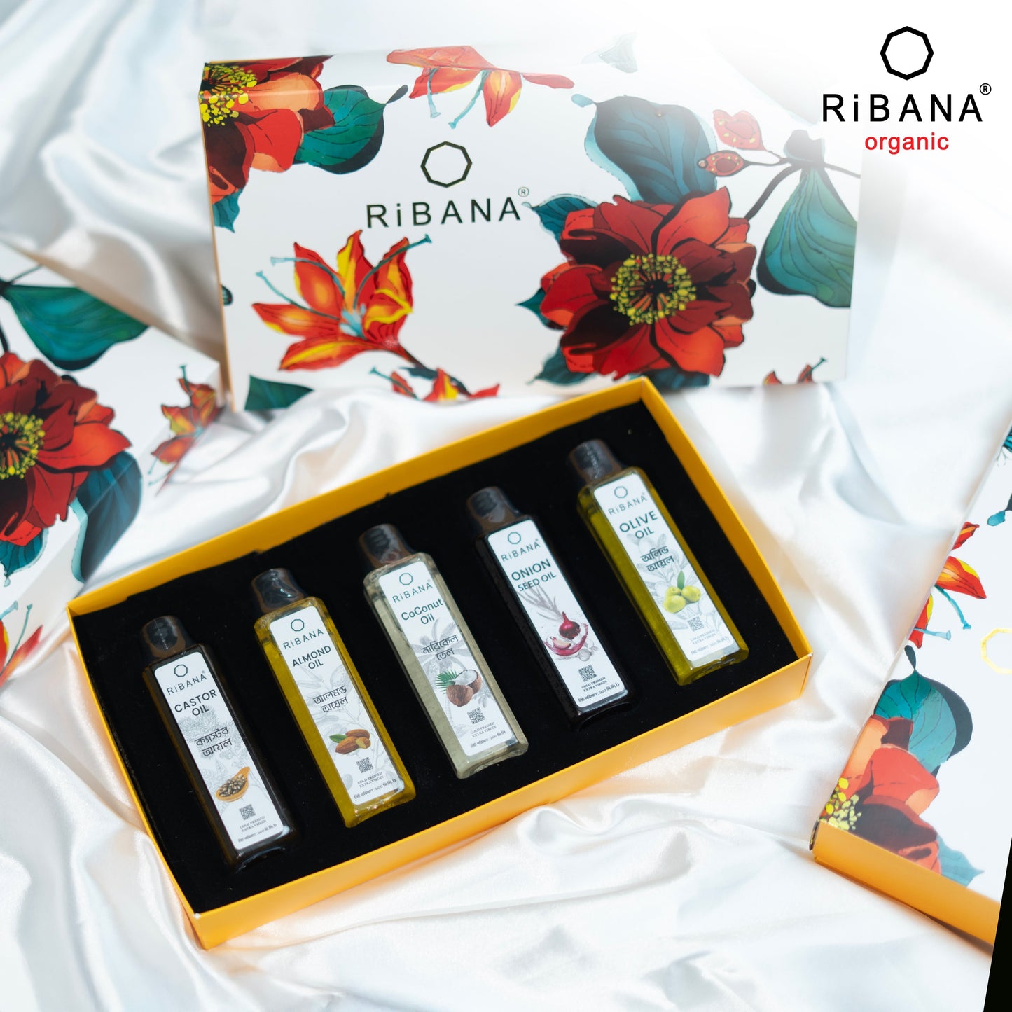Ribana Organic Oil Combo Gift Box with five 100ml bottles of coconut, olive, castor, onion seed, and almond oils in a floral-designed box