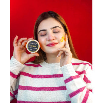 RiBANA Saffron Gel 130ml for brighter skin and reducing acne spots, held by a smiling person.