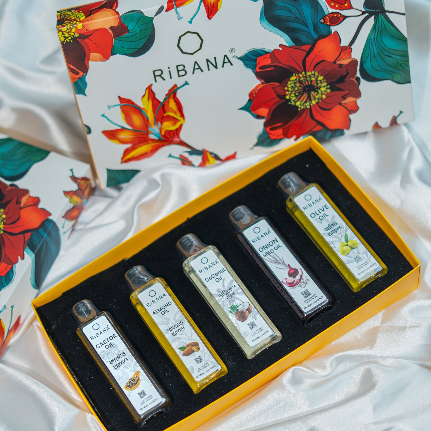 Ribana Organic Oil Combo Gift Box with five 100ml bottles of coconut, olive, castor, onion seed, and almond oils in a floral decorated box